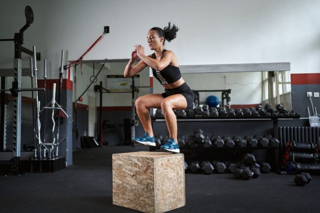 young-female-athlete-jumping-on-a-box-at-the-gym-royalty-free-image-1640825791