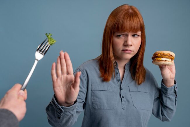 person-with-eating-disorder-trying-to-eat-healthy_23-2149243031